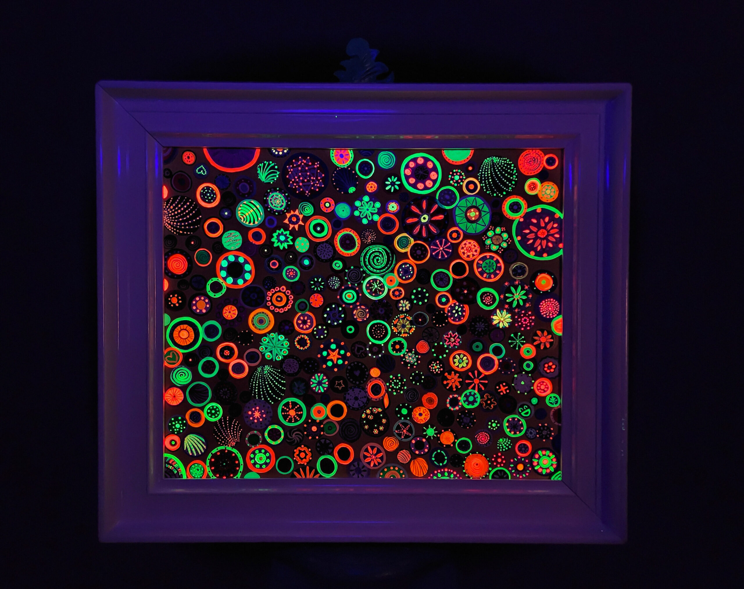 This artwork comes with an antique frame that was hand-painted. The creation of this original fluorescent artwork was inspired by the cosmos' magic and the astronomical design of the infinite universe. The planets, stars, and asteroids had always fascinated me since I began observing the milky way from my grandmother's garden in the night when I was in Mexico. The skies in small towns in Mexico are clearer because there is not much pollution that can prevent us from seeing these stellar scenes of the nature of the universe. The combination of relational art is an interaction of the human being and the art object, such as this fluorescent painting that glows in the dark with UV light. I painted many unique designs in each circle that brings a lot of happiness and color to our lives, well, even more joy than what is already in our hearts.