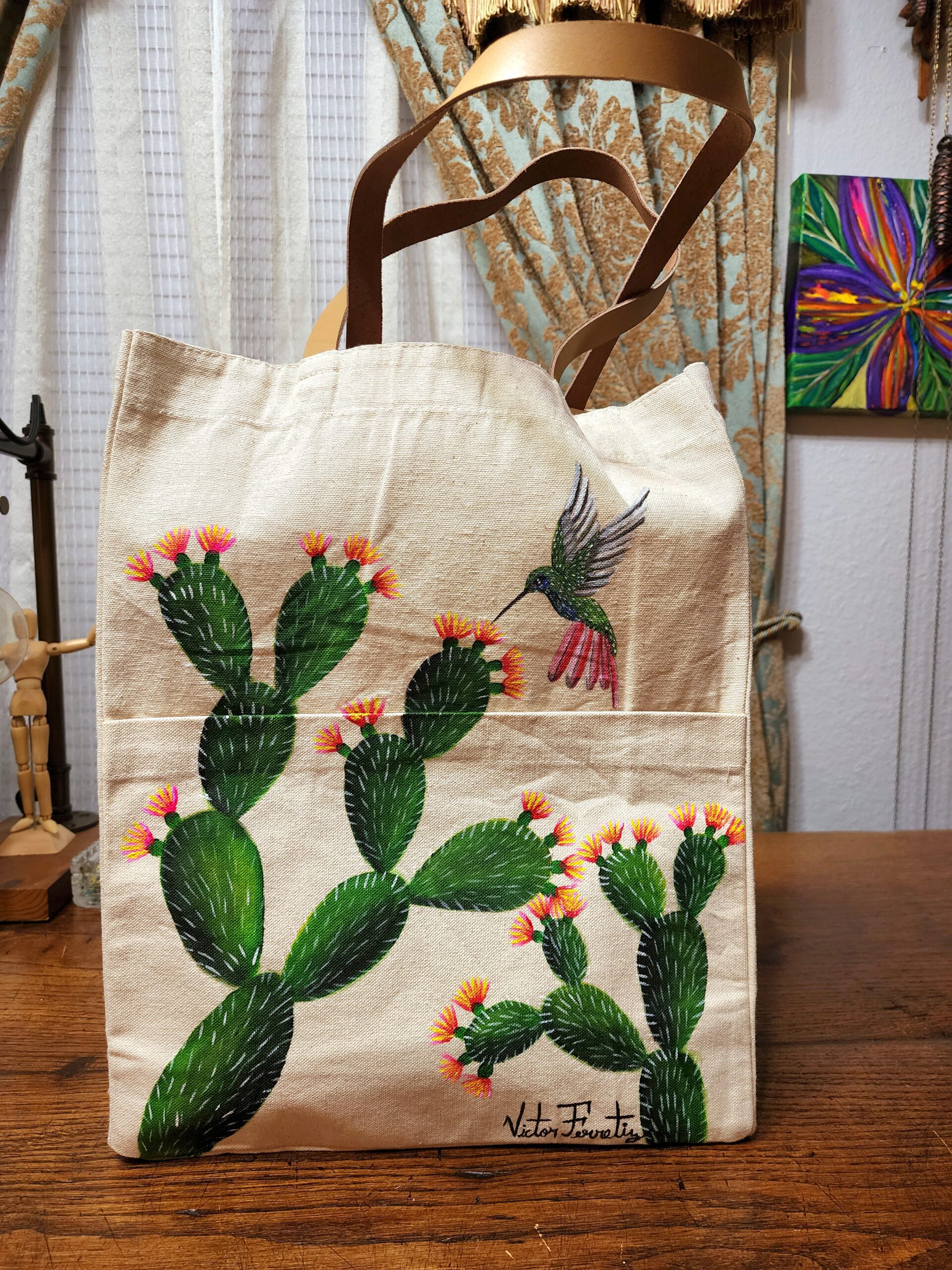Original hand-painted tote bag with a front pocket and leather handles. Tote bag signed by the artist.