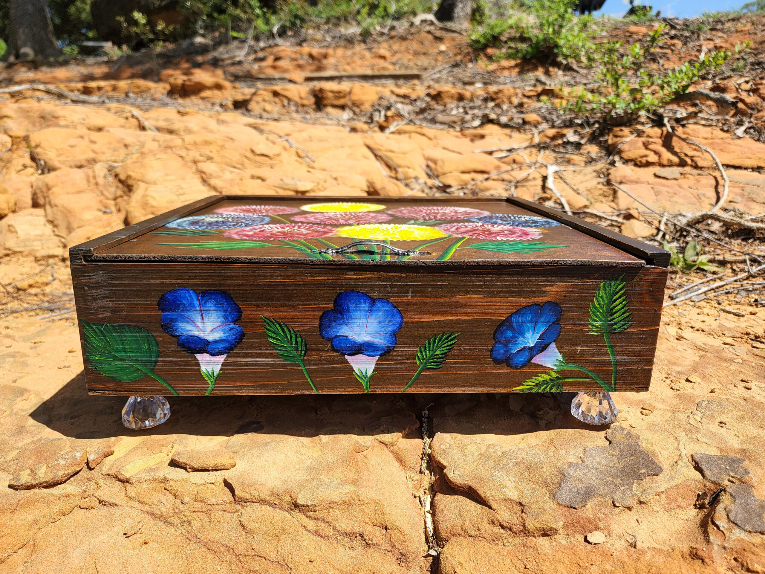 This is one of a kind handpainted wood trinket box with layers of felt inside, crystal feet, a metal handle, a love stencil mirror, and circle cut mirrors. This cute trinket box is an ideal gift for a special loved one. You can store jewelry such as rings, necklaces, bracelets, or anything you would like to keep in a particular place, especially in this elegant and artistic trinket box.