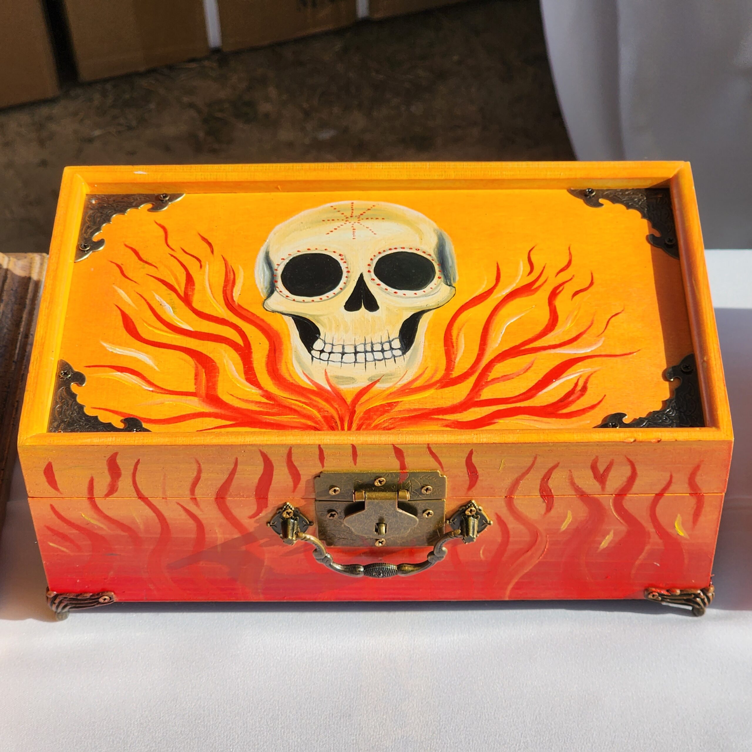 Beautiful handpainted wooden trinket box with a mirror and metal feet. This cute skull trinket box is an ideal gift for a special loved one. You can store jewelry such as rings, necklaces, bracelets, or anything you would like to keep in a particular place, especially in this elegant and artistic trinket box.