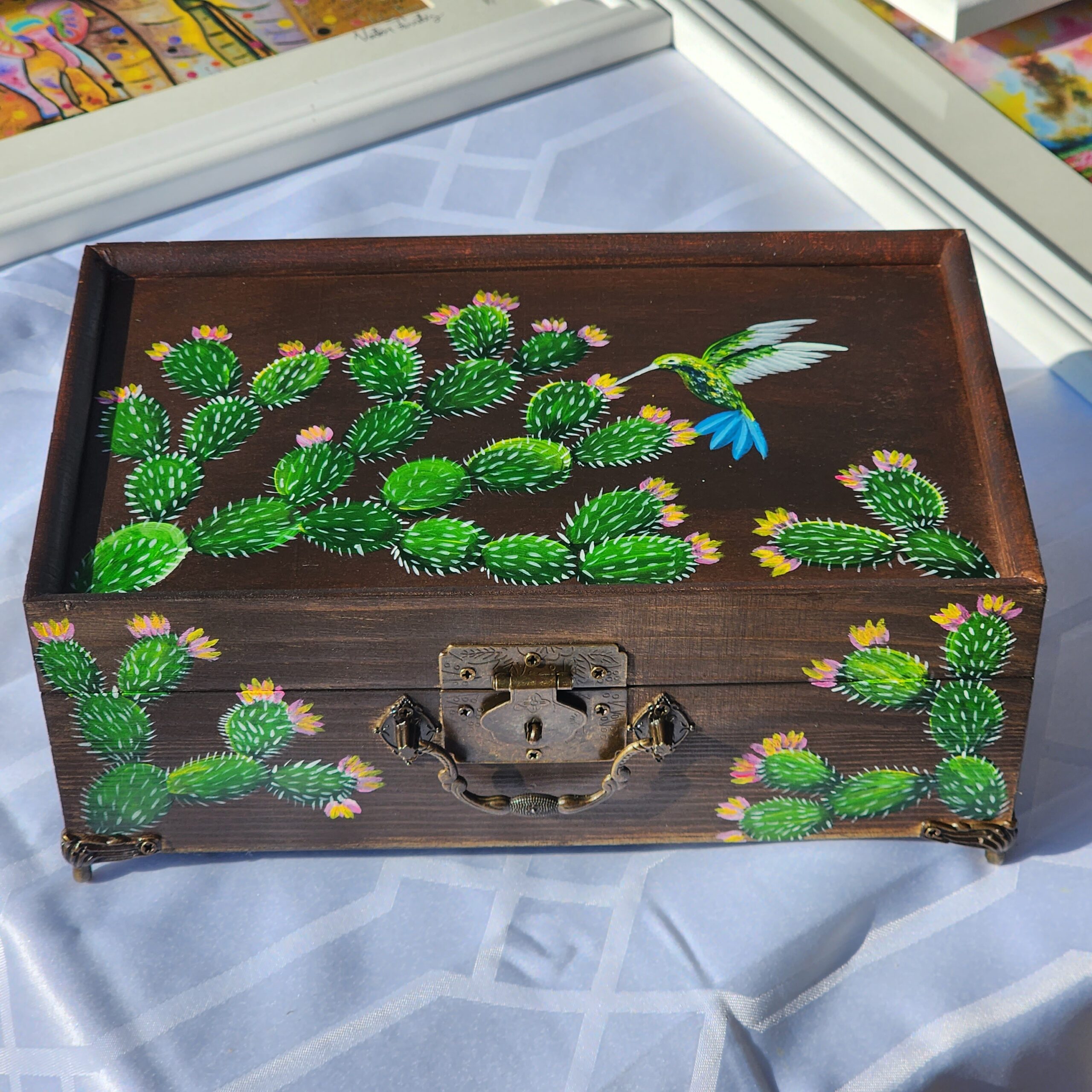 Beautiful handpainted wooden trinket box with a mirror and metal feet This cute trinket box is an ideal gift for a special loved one. You can store jewelry such as rings, necklaces, bracelets, or anything you would like to keep in a particular place, especially in this elegant and artistic trinket box.