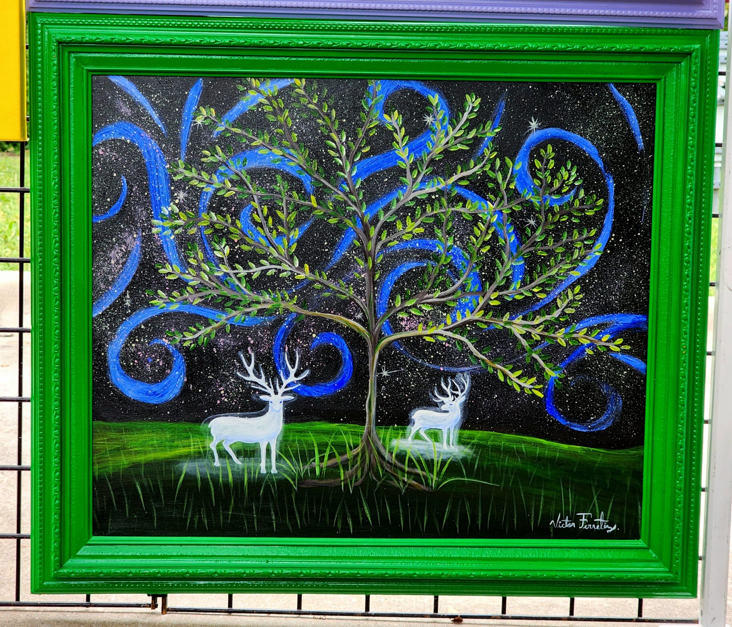 Surrealistic/magical depiction of glowing deers under a magical sky with a tree. Painted wooden frame. Painting size: 20″x24″
