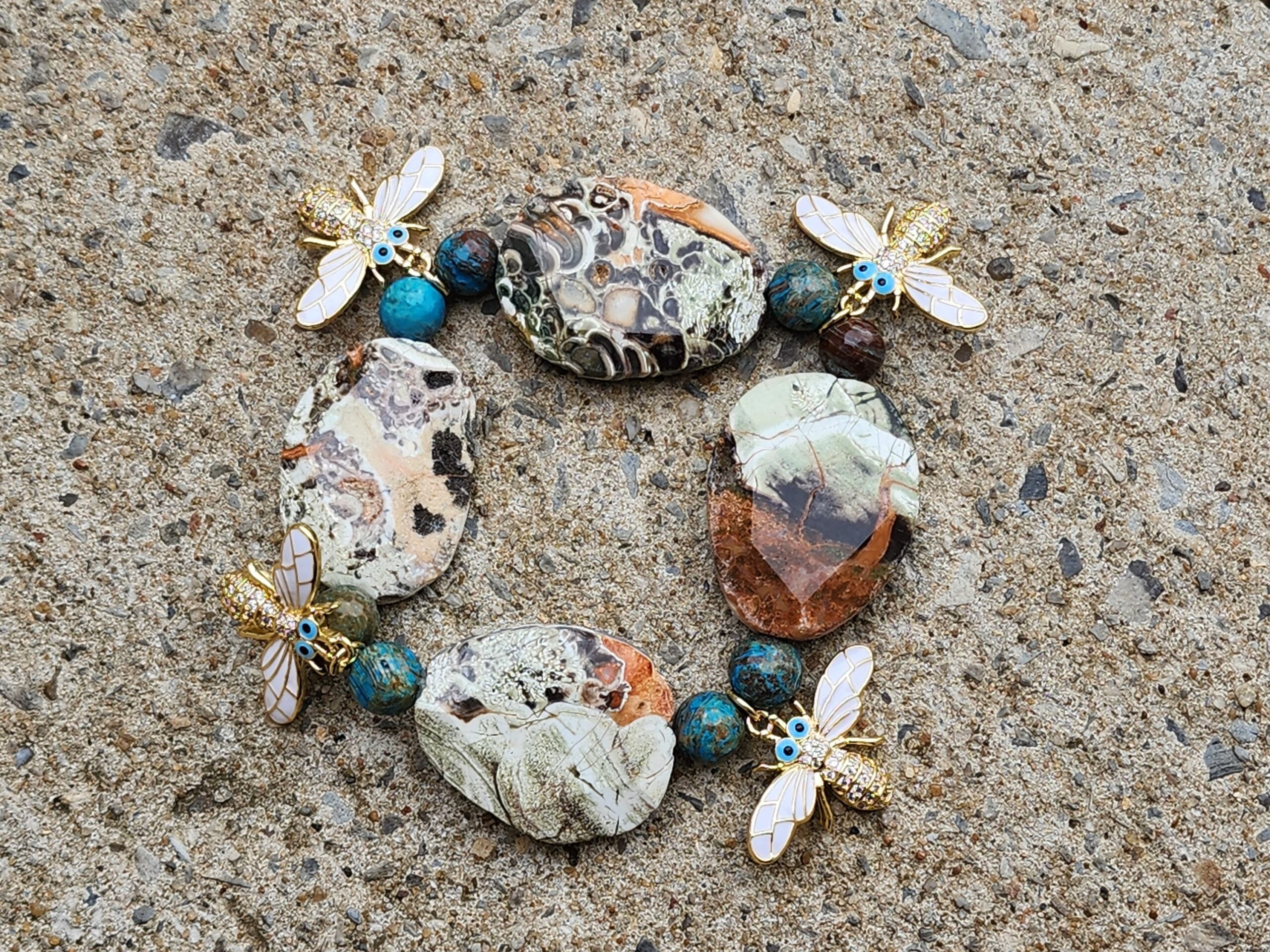 This bracelet is handcrafted with crazy lace agate, turquoise, and metal bee charms. Crazy lace agate is a stone of optimism that promotes personal joy. It can also help you leave a negative relationship and find a new positive situation. Crazy lace agate is said to: Promote mental agility, liveliness, and variety Encourage flexibility in thinking and action Balance emotional, physical, and intellectual energy Harmonize the Yin and Yang, the positive and negative forces of the universe Signify strength, fortitude, confidence, and decision-making skills.