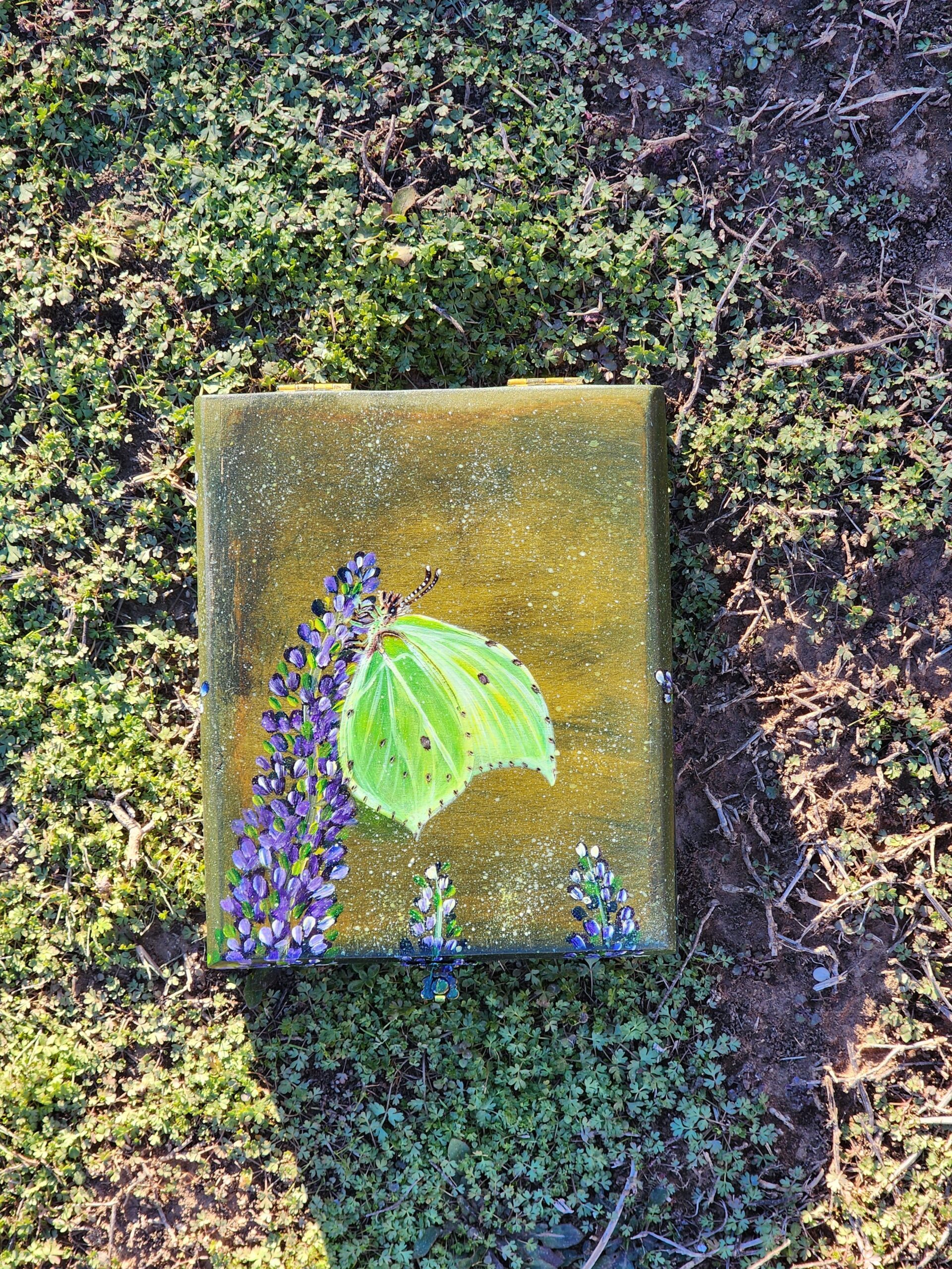 Repurposed antique wooden jewelry box with original design of a beautiful lime green Brimstone Butterfly extracting nectar from delicious aromatic lavender. Metal feet and original clasp. Removable foam ring pad.