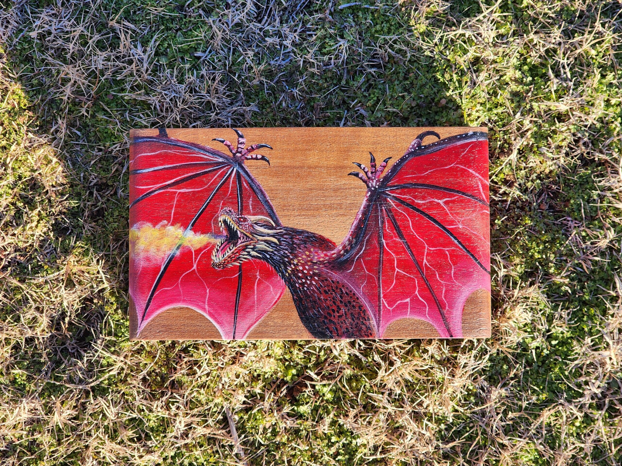 Repurposed antique wooden jewelry box with original design of a dragon.