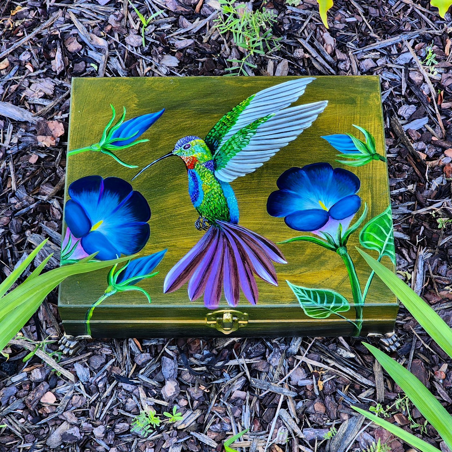 This box was repurposed into a jewelry / trinket box with a magical design of a hummingbird and some morning glories. Brass feet were assembled to the box. The box has been varnished already.