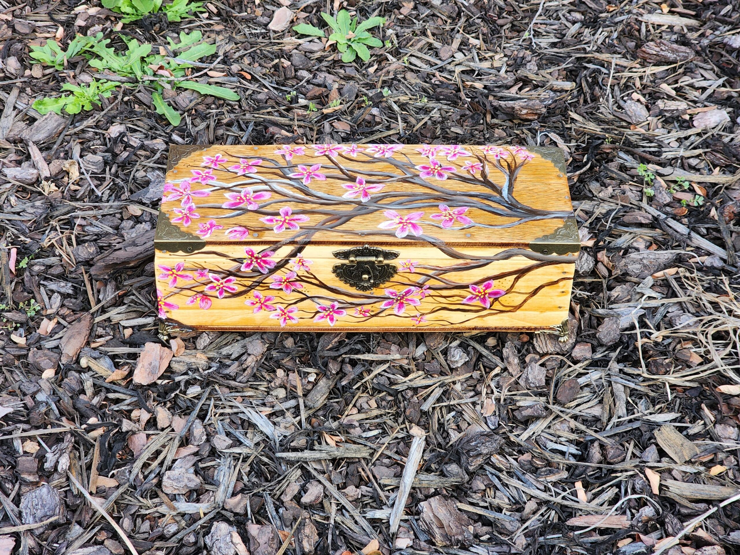 This is an antique box that was repurposed into a very beautiful jewelry box with a cool design of a cherry blossom tree.