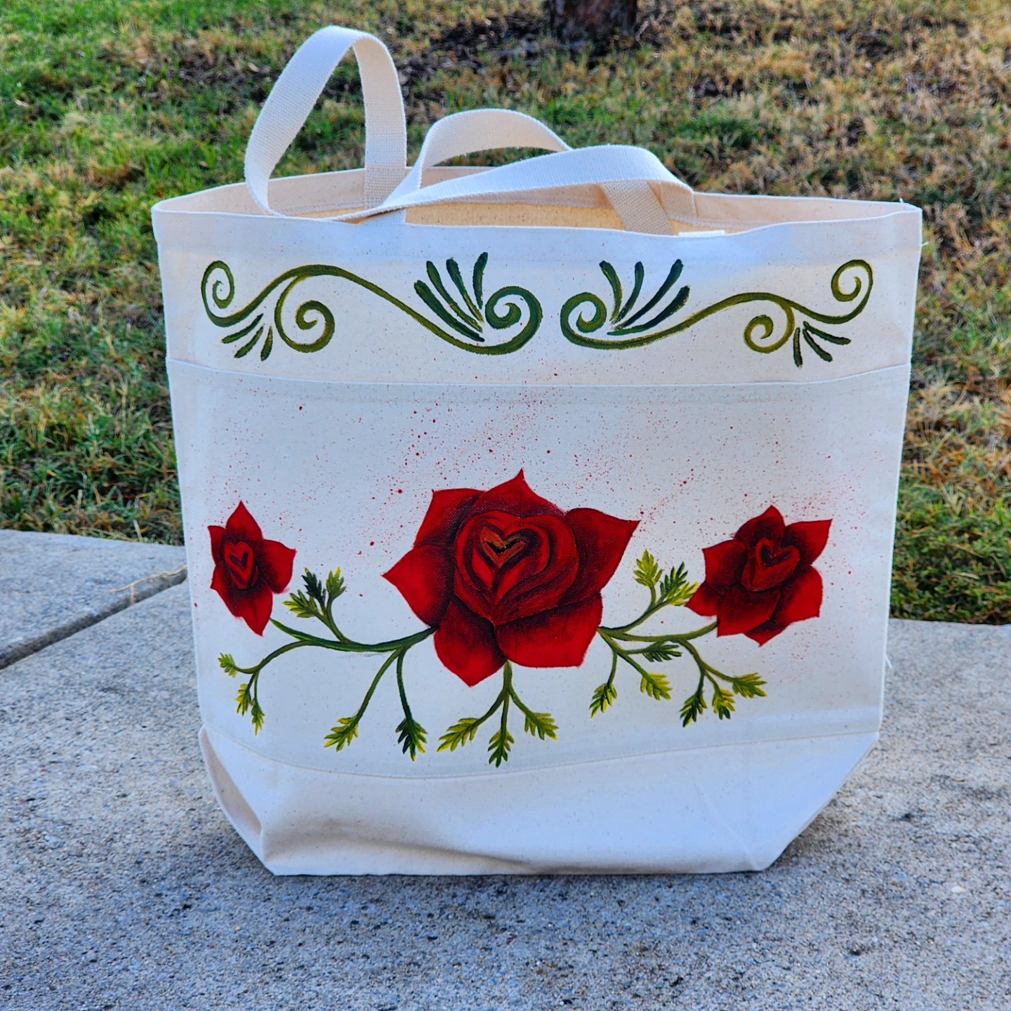 This is a handpainted tote bag with a desing of some roses. This bag was painted with textile paint on tote fabric. Size: 20x20 inches. Washer and dryer safe.