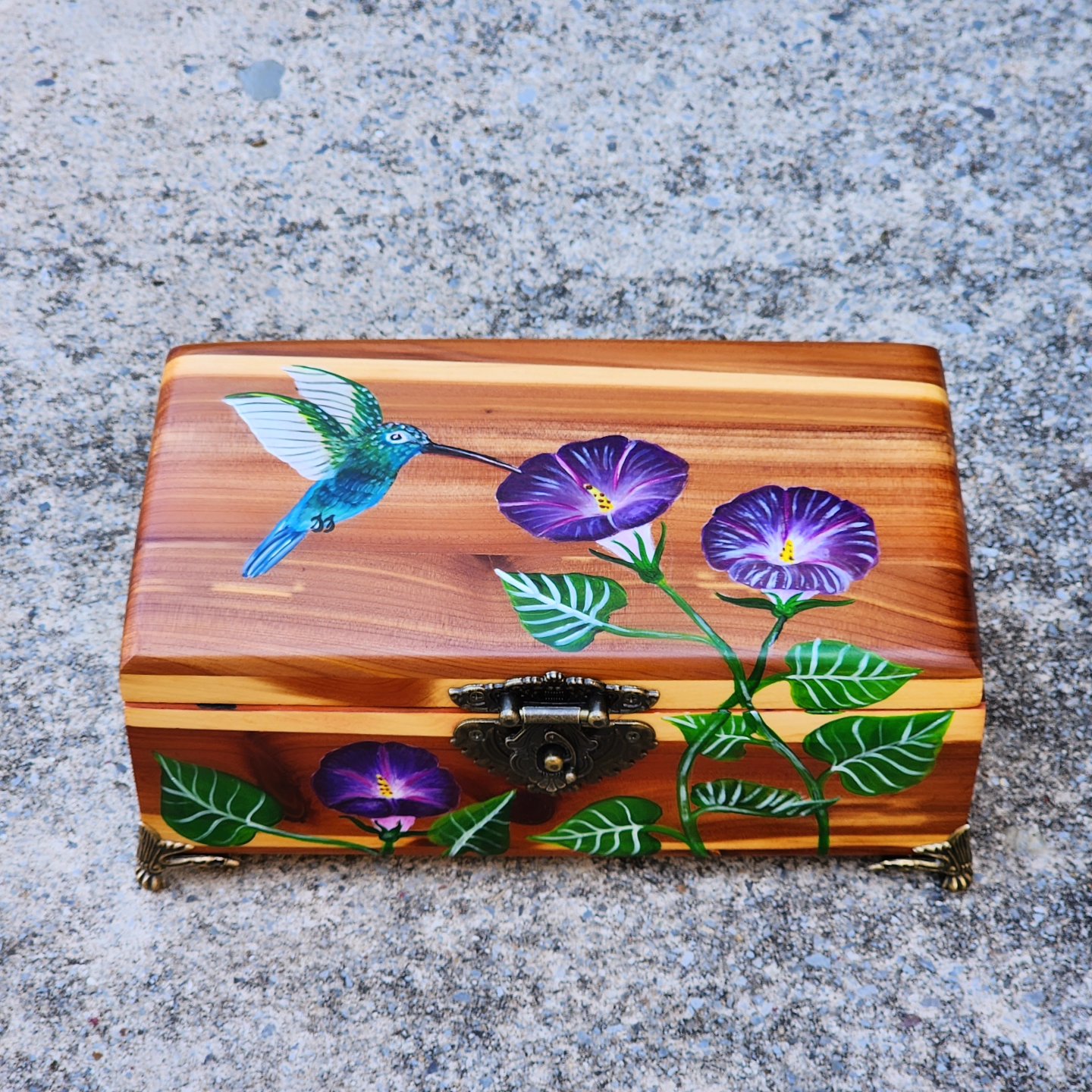 Antique wooden jewelry box with original design of a hummingbird flying over morning glories. Dimensions of box in inches: 5 length x 9 width x 4 height.