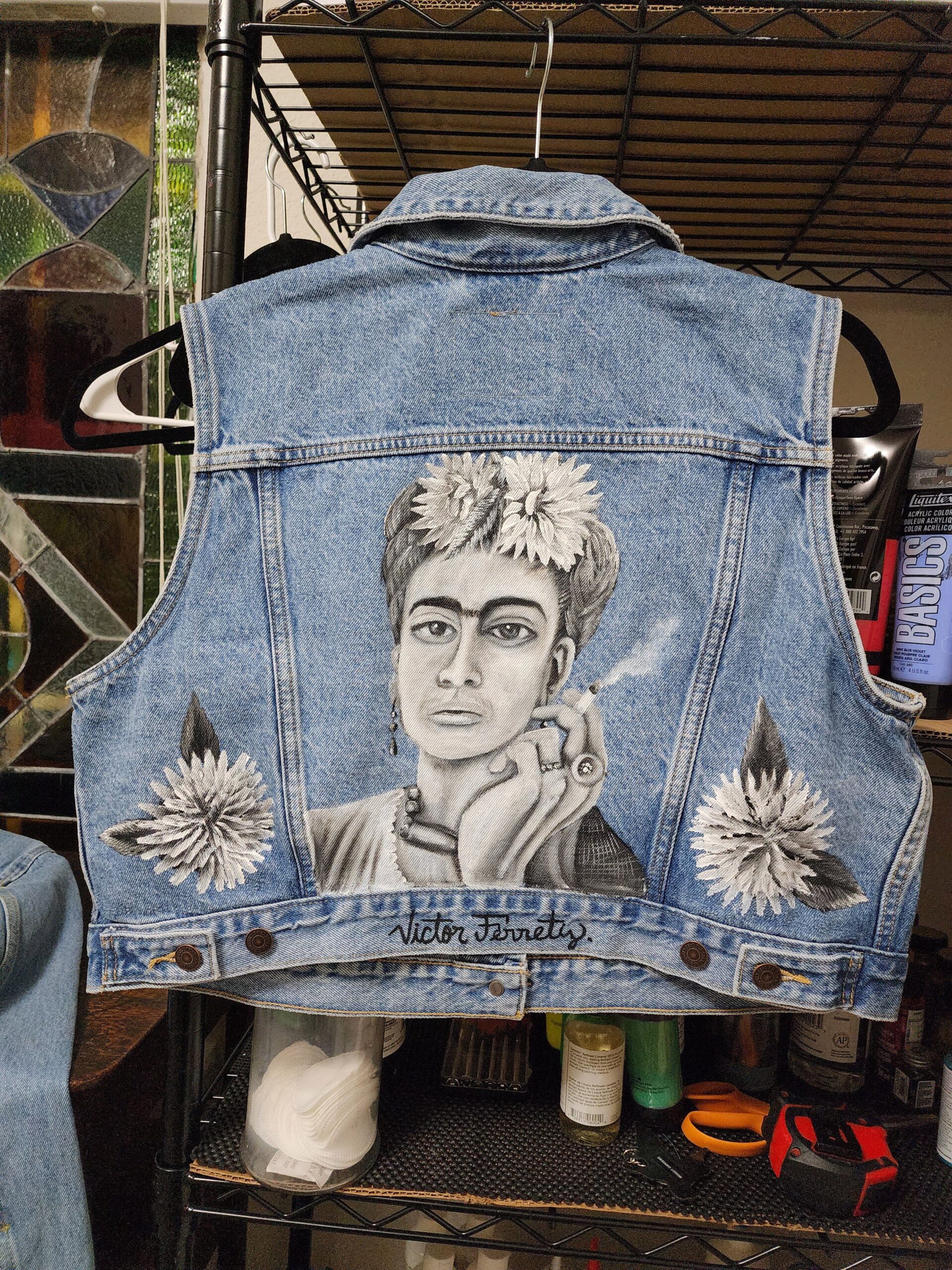 I am very excited because I’m creating these beautiful Levi’s vests for women. The design is stylized with a portrait of Frida Kahlo. The vest has been heat-pressed, so this process seals the paint permanently, and it won’t come off. Brand: Levi’s Size: XL (women)